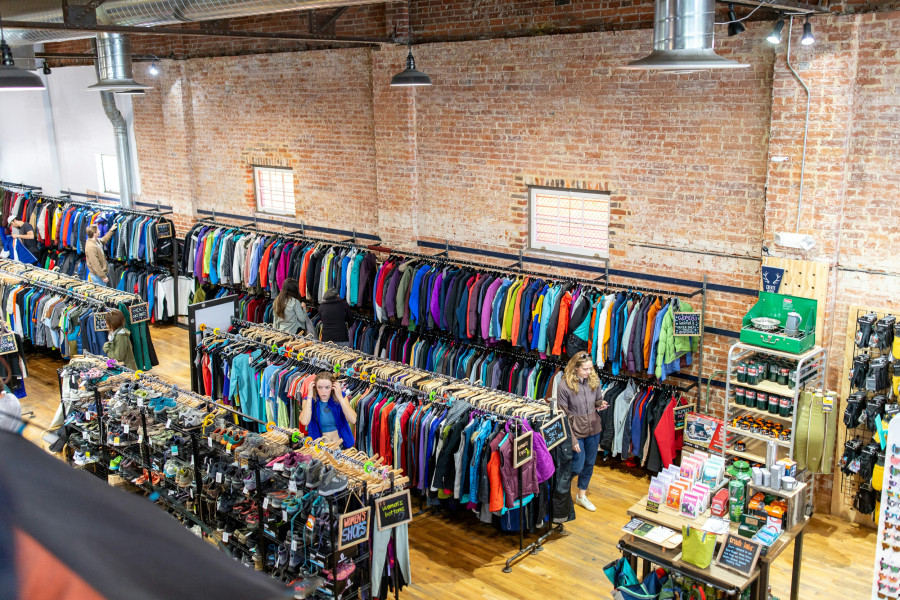 A high-angle wide shot of a thrift store secondhand shopping