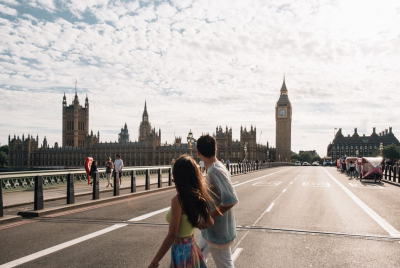 Couple walking on Westminster Bridge with Big Ben in the background