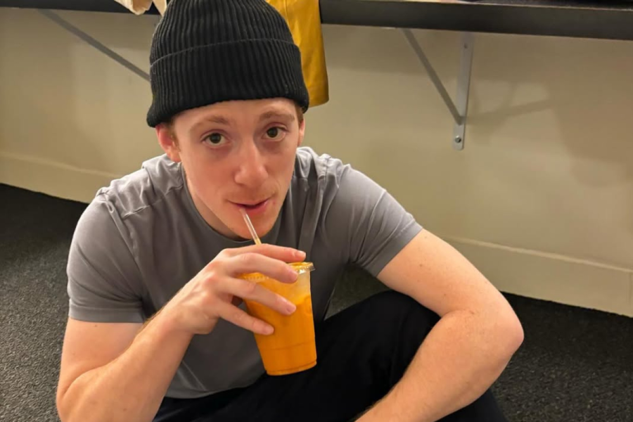 Ethan Slater drinking orange juice