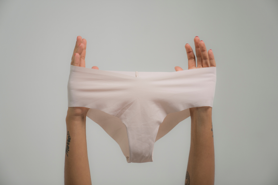 Person Holding a White Underwear