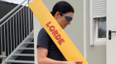 Lorde wearing sunglasses for a candid photo