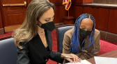 Zahara Jolie-Pitt with Angelina Jolie signing papers