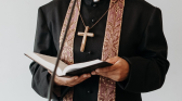 Pastor holding a biblical book