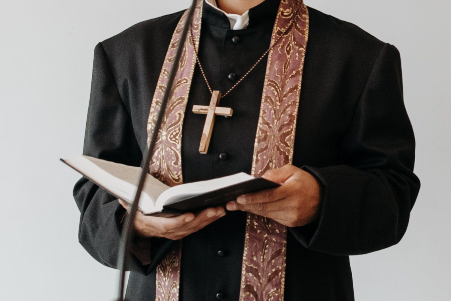 Pastor holding a biblical book