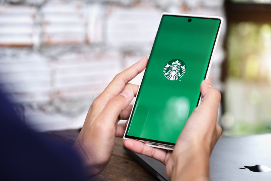 Woman Hand Holding Smart Phone Mobile Opening Starbuck App