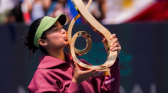 Alex Eala kissing her trophy