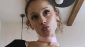 Ariana Grande pouting for a photo with curls