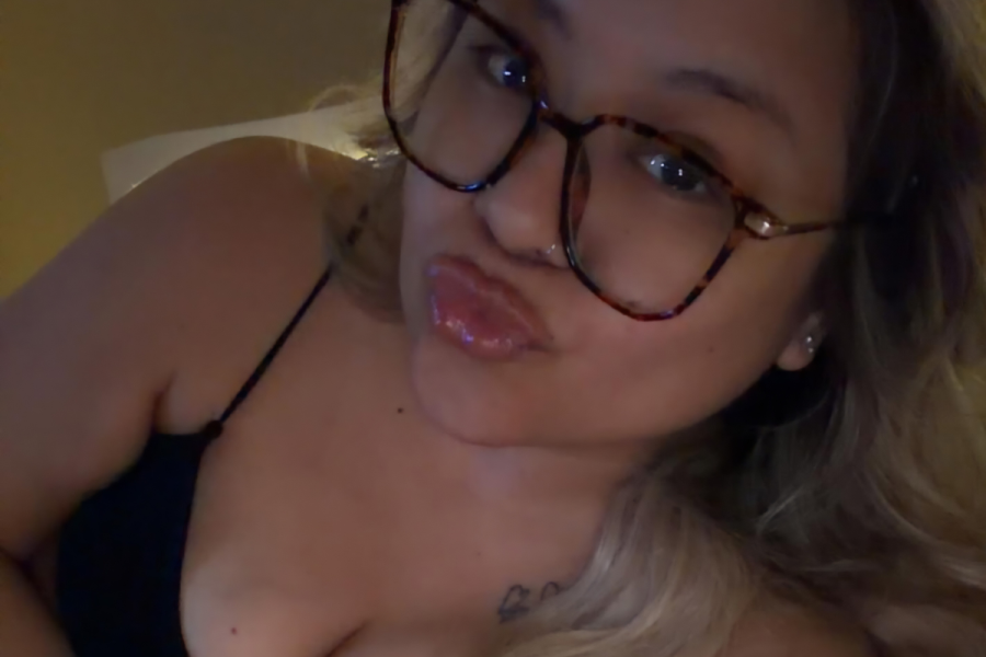Ash Trevino with eyeglasses pouting for a photo