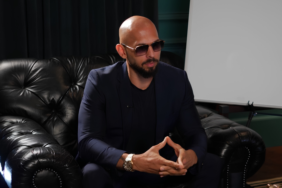 Andrew Tate in a formal attire wearing sunglasses