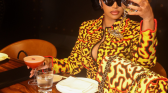 Cardi B posing with her yellow channel bag