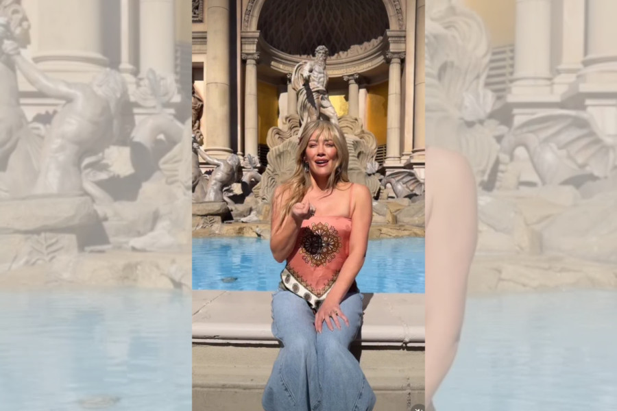 Hilary Duff tosses a coin into a fountain in Las