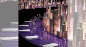 Illuminated miniature New York skyline on Hermès dinner table