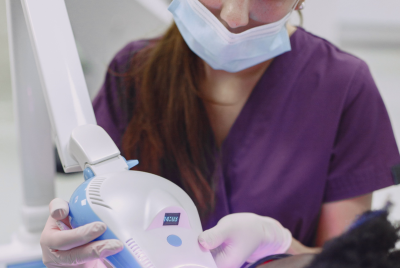 Dentist in purple scrubs